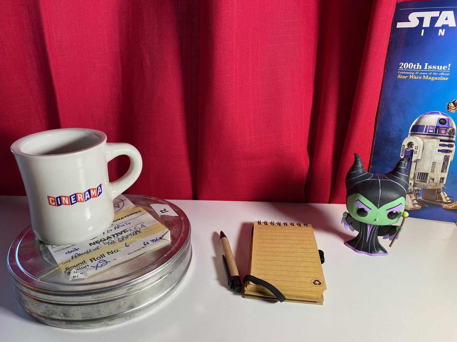 Amy Richau's desk with film reel, notebook, and collectibles